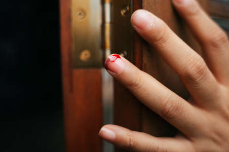 Skin around nail is torn and bleeding.