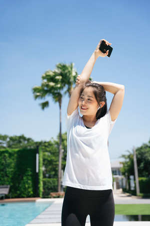 Healthy asian woman stretching arms warm up before exercise.