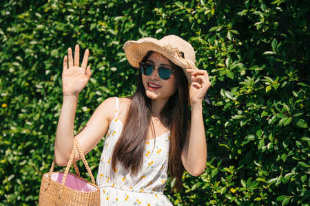 Portrait of beautiful asian traveler woman wearing hat and sunglasses on nature background.