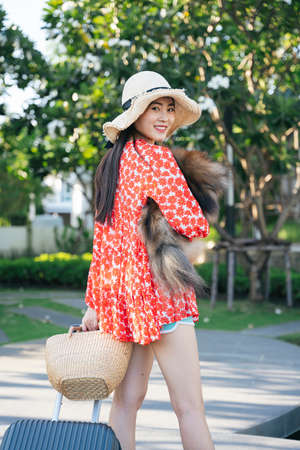 Beautiful asian traveler woman travel with her dog in resort and hotel.