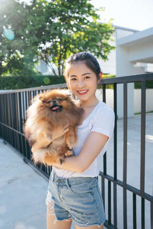 Portrait of asian woman and pomeranian spitz dog.の写真素材