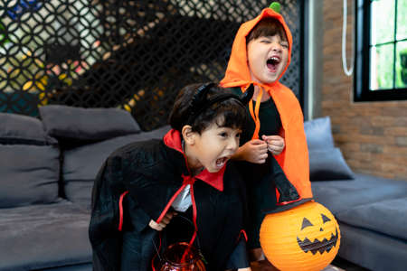 Sister and brother in halloween costume having fun in the party.の写真素材
