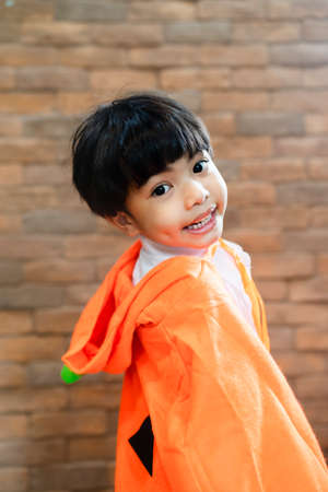 Portrait of asian boy wearing punkin hood for halloween party.の写真素材