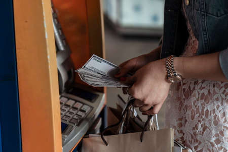 Hand of woman holding money banknote withdrawned from ATM.の写真素材