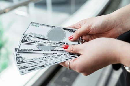 Bunch of banknote counting money cash. Woman hand holding cash.の写真素材