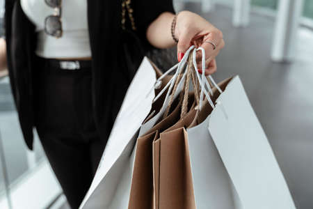 Close up hand of shopping woman holding paper bags.の写真素材