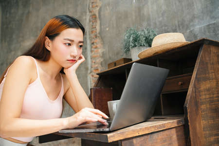 Young asian woman using laptop computer for working at home.の写真素材