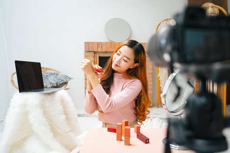 Beautiful influence woman doing cosmetic vlogging show for social media infront of camera.の写真素材