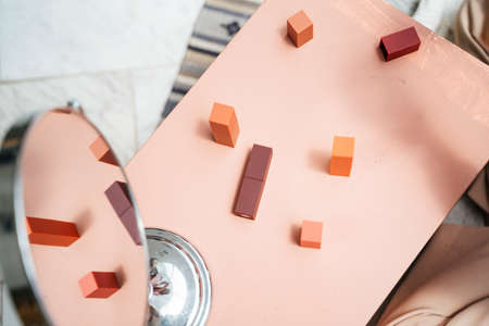 Pink table with many cosmetic products and mirror.の写真素材