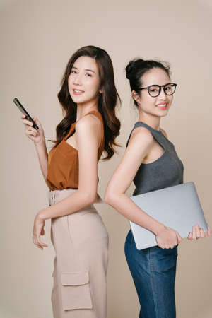Portrait of two asian business women in casual shirt standing together.の写真素材