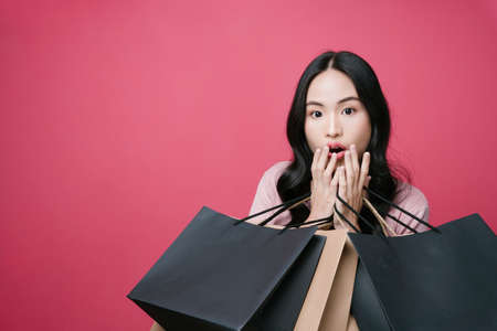 Shopping lover holding many shopping paper bags.の写真素材