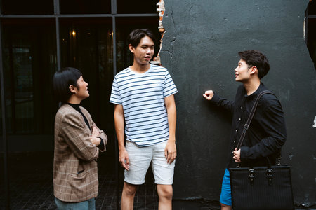 Three young business people in casual shirt take a break after meeting in cafe.の写真素材