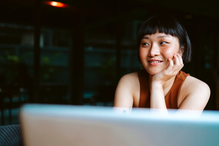 Asian short hair woman working with laptop computer in cafe.の写真素材