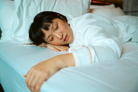 Asian short hair woman sleeping on bed in the morning.の写真素材