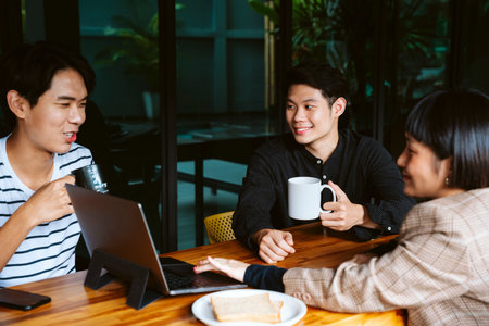 Business people have a meeting at cafe outdoors together.の写真素材