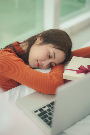 Beauty young asian woman black hair sleeping infront of laptop in christmas day.の写真素材