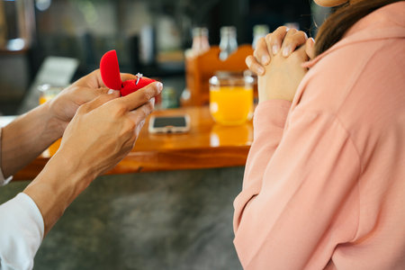 Will you marry me. Man asking woman for marry giving engagement ring from red box. Romantic...