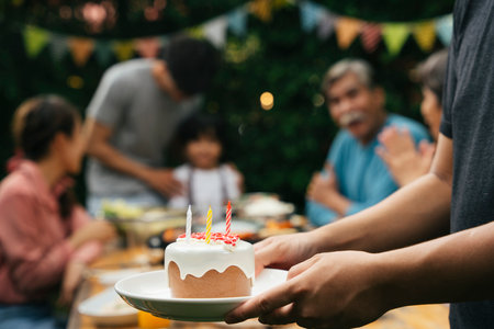 Birthday cake on white plate with candles on top.の写真素材