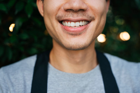 Close up of asian man with mustache with white teeth.の写真素材