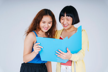 Gym coach and member looking at BMI document paper isolate on white background.の写真素材