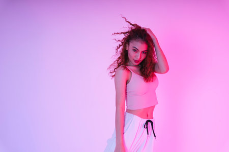 Beautiful young asian girl with an afro curly hairstyle in neon light studio.の写真素材