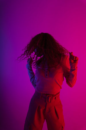 Fashion portrait asian girl dancing on neon light studio background.の写真素材