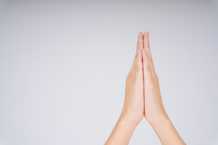 Woman hand praying symbol hold hand together. Pray and gratitude. Hello, Thank you, and good bye in Thai meaning.の写真素材