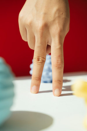 Two fingers walking among covid-19 pendemic over red background.