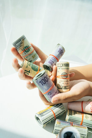 Rich people with lot of rolled bank note on hands. Rich people with money.の写真素材