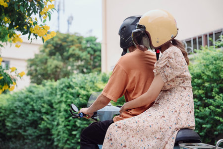 Taxi motor biker and woman customer on the road. A motorbike taxi transports a passenger on a city...