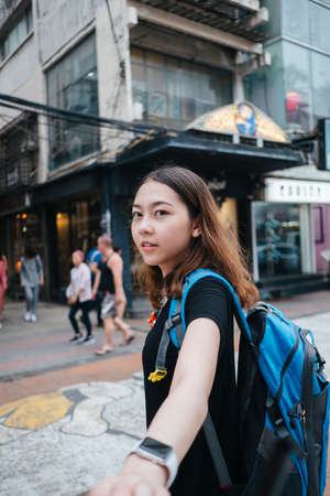 Beautiful young asian woman backpacker traveling in Bangkok city downtown.の写真素材