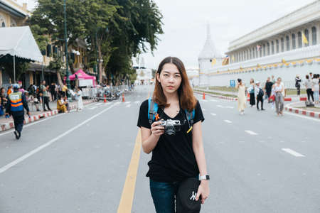 Portrait of young asian woman travel in Bangkok standing on the road near wat arun area.の写真素材