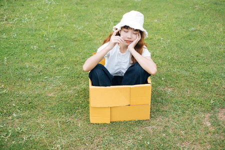 Playful young asian thai woman hipster curly hairstyle on white shirt and hat sitting inside...