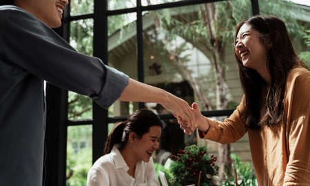 Thai young business doing handshake with smile on their face before getting in business.の写真素材