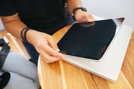 Cropped image of tablet in the man's hands and the girl point to the display.の写真素材