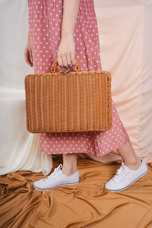 Picnic in autumn concept. Woman holding picnic basket. Mock up.の写真素材