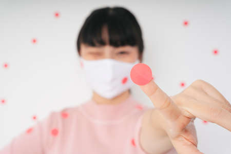 Fashion portrait - Beautiful asian thai long dark hair woman wearing surgical white mask isolate over white background.の写真素材