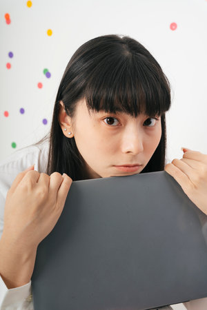 Close up - Beautiful asian thai long dark hair woman with laptop isolate over white background.の写真素材