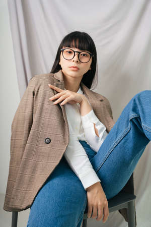Beautiful asian thai long dark hair woman in white shirt wearing eyeglasses. Fashion portrait. Hipster.の写真素材