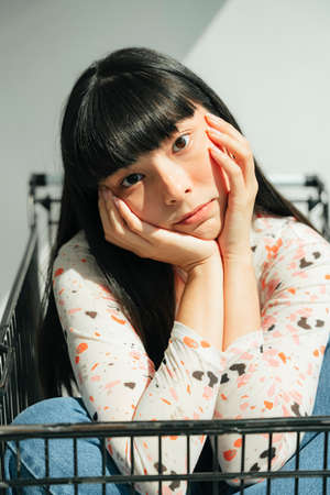 Fashion portrait - Beautiful asian thai long dark hair woman inside shopping cart.の写真素材