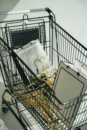 Messy shopping cart with cloth hanger and paper bag. Mock up.
