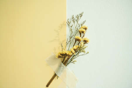 Mock up yellow paper and flower bouquet over yellow background. Copy space.の写真素材
