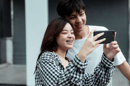 Teenage couple take a photo of the city during their dating.の写真素材