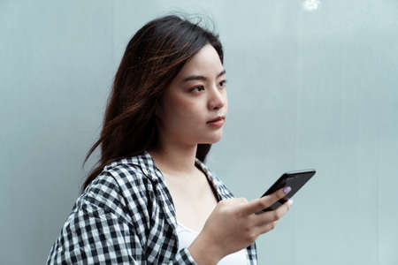 Close up shot of woman's hand holding her smartphone for checking.