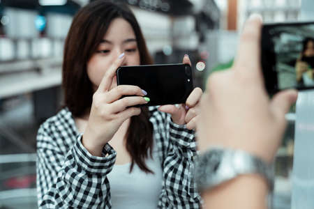 Teenage couple take each other photo during their dating with happiness.の写真素材
