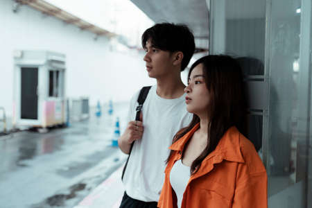 Teenage couple standing at the entrance of parking lot in the shopping mall.の写真素材