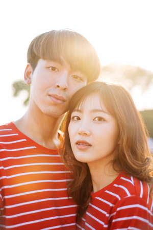 Portrait shot of young couple in the sunlight of evening.