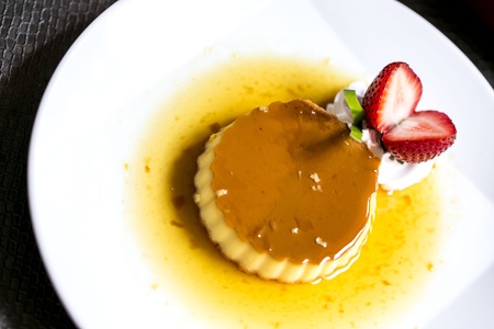 caramel custard with Whipped cream and strawberryの写真素材