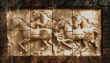 Stone sculpture of horse on wallの写真素材