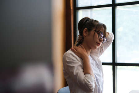 Asian women sitting on chair and relaxing in her room.の写真素材